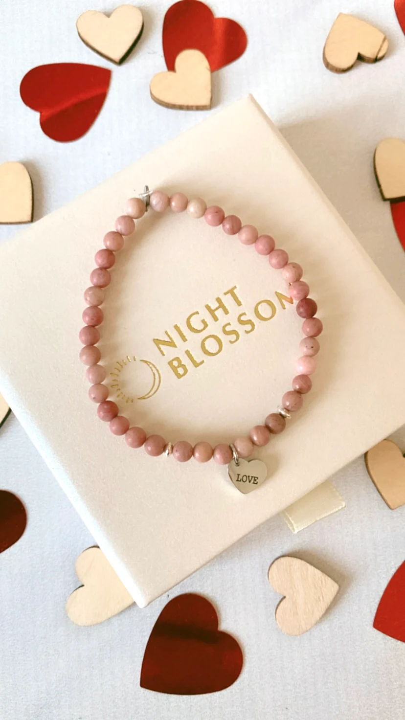 Personalized stone bracelet with engraved charm displayed as a thoughtful Valentine's Day gift idea. 