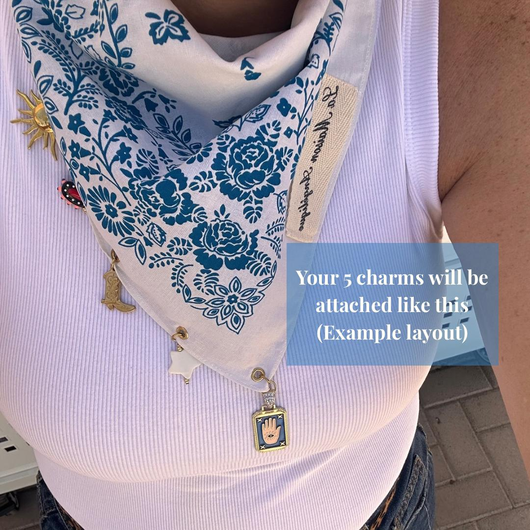 Bandana with decorative charms, styled as a playful and versatile accessory that can be worn to tied to a bag