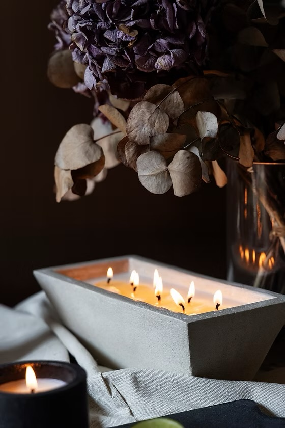 Sustainable candle by Innara made from reclaimed materials for warm home ambiance during Eid Al Adha.